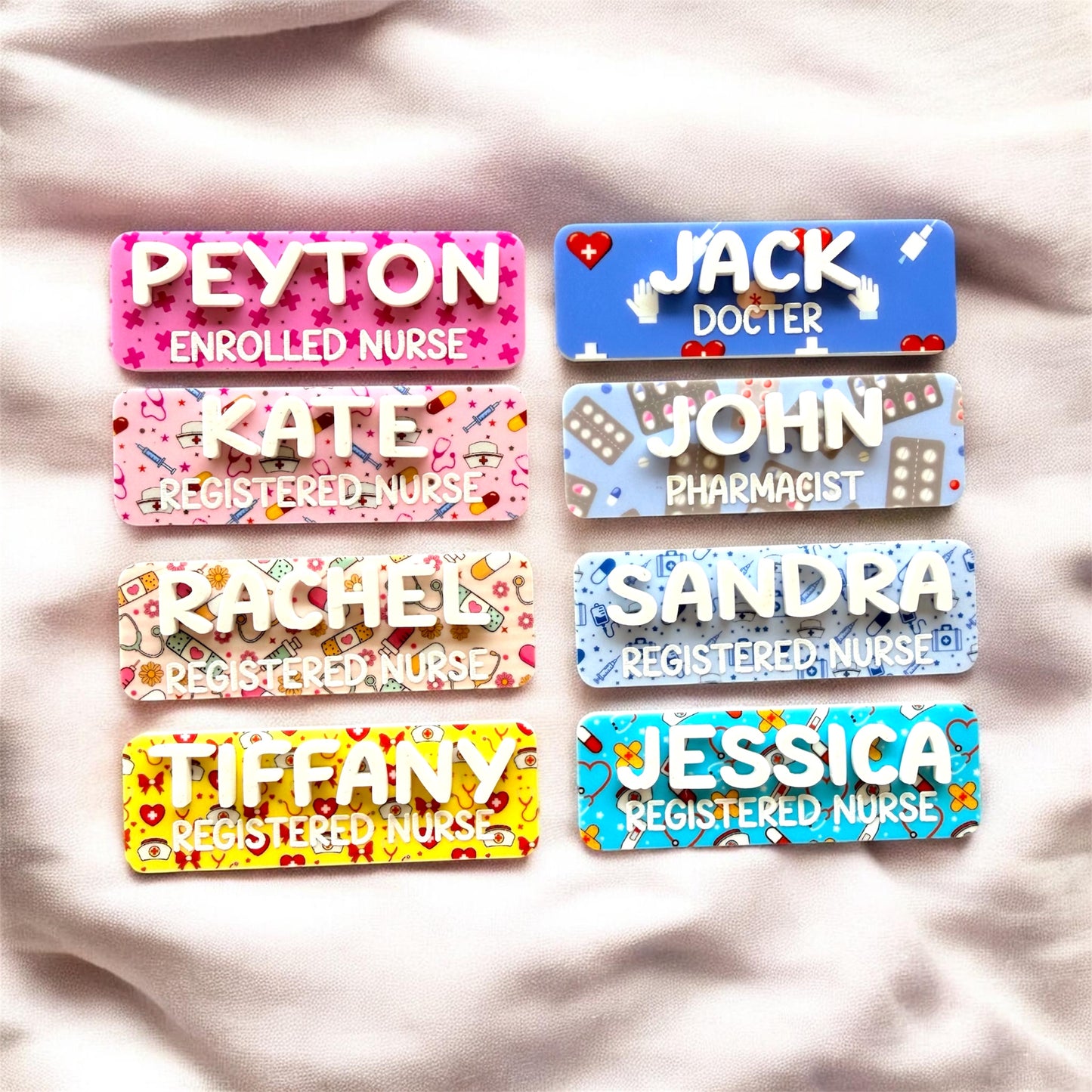 Set of colorful name tags with personalized names on a soft fabric background