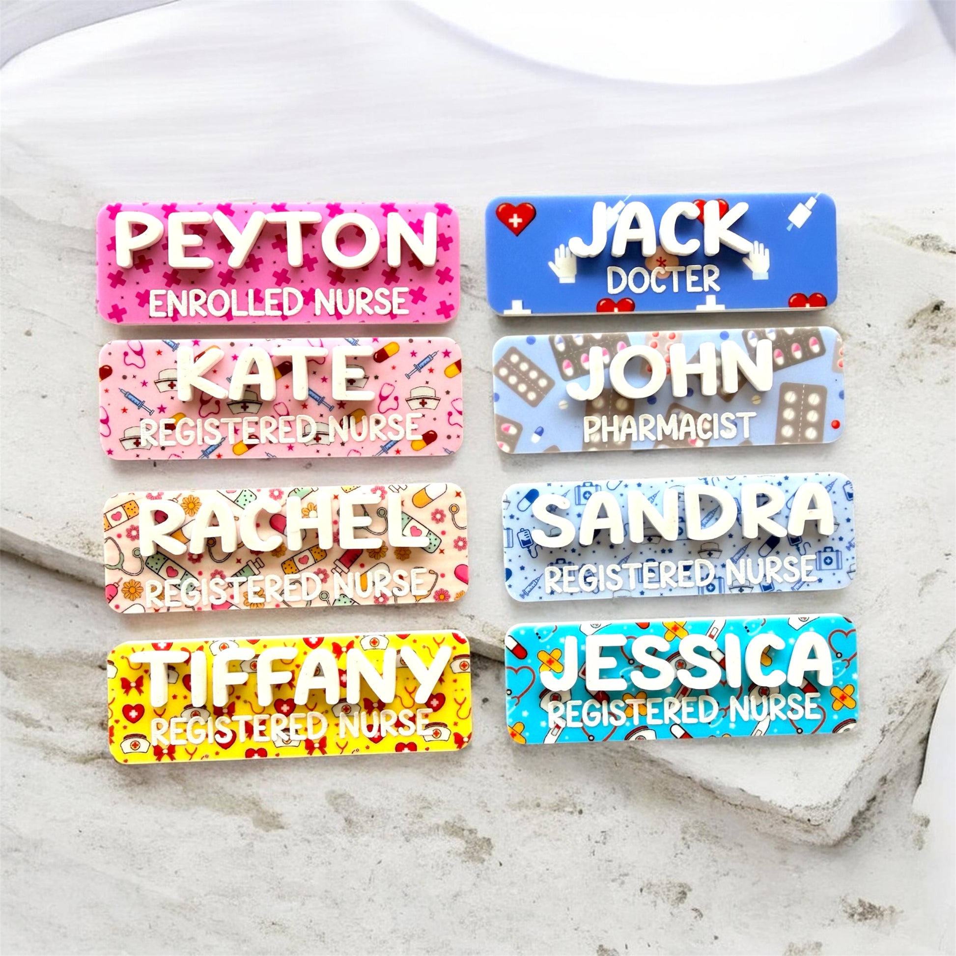 Set of colorful name tags with different professions on a textured surface