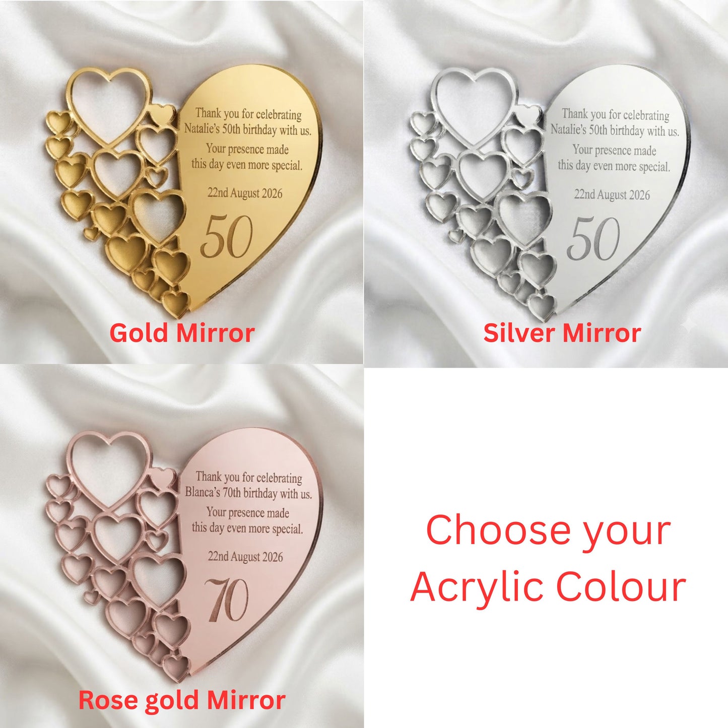 Four acrylic heart-shaped commemorative plaques on a white satin background, showing gold, silver, and rose gold finishes. The plaques feature layered heart outlines and engraved text including the number 50 or 70 and a birthday message.